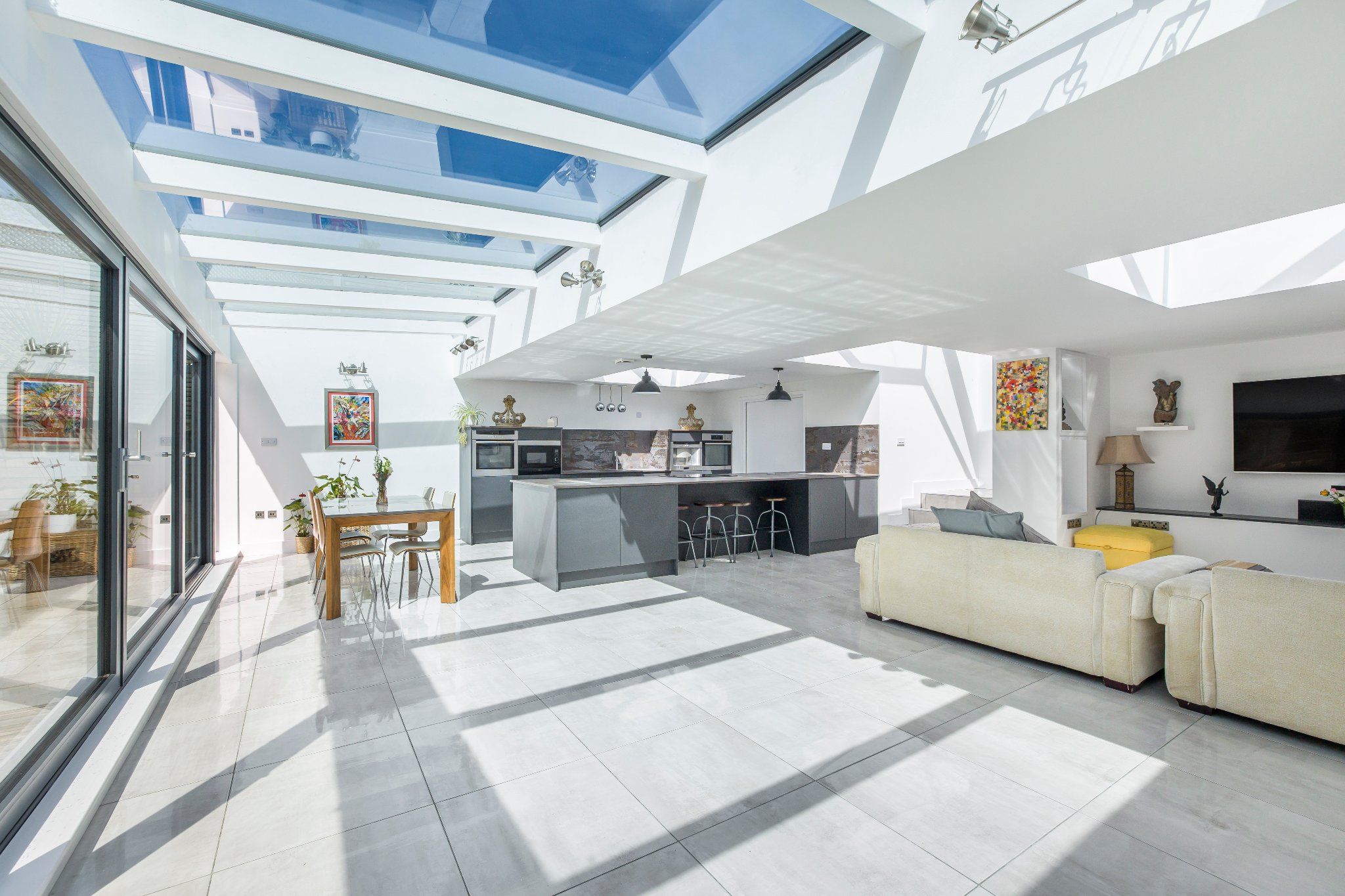 Open-plan kitchen-diner with glass roof after full house refurbishment